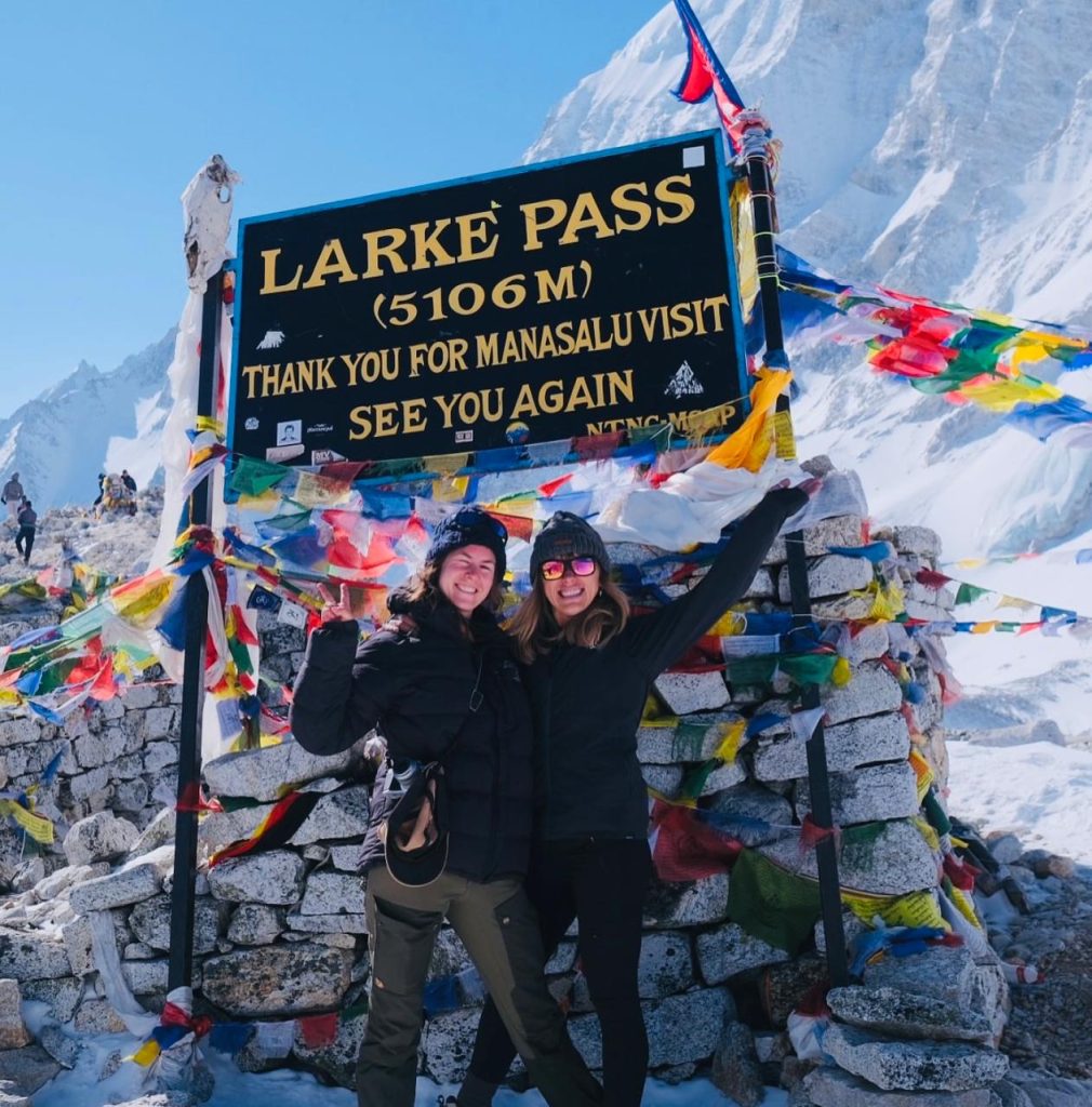 Two trekkers celebrating at Larke Pass (5106m), Manaslu Circuit Trek.