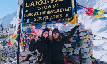 Two trekkers celebrating at Larke Pass (5106m), Manaslu Circuit Trek.