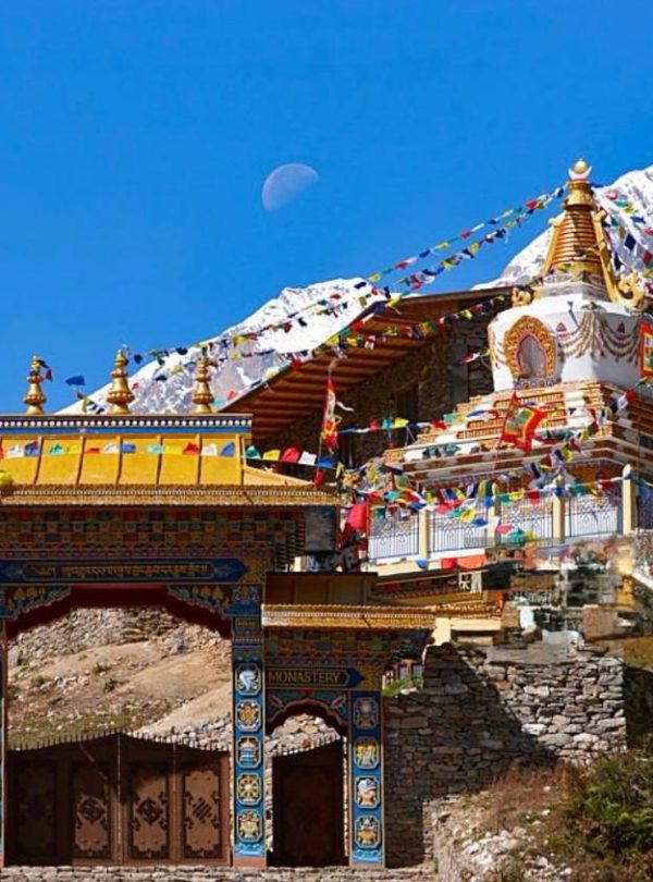 Buddhist monastery in Manaslu region with snowcapped Himalayan mountains.