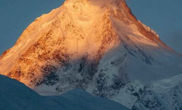 Golden sunrise on Mount Manaslu peak during the Manaslu Circuit Trek in Nepal.