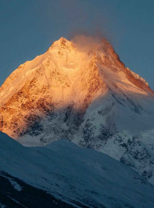 Golden sunrise on Mount Manaslu peak during the Manaslu Circuit Trek in Nepal.