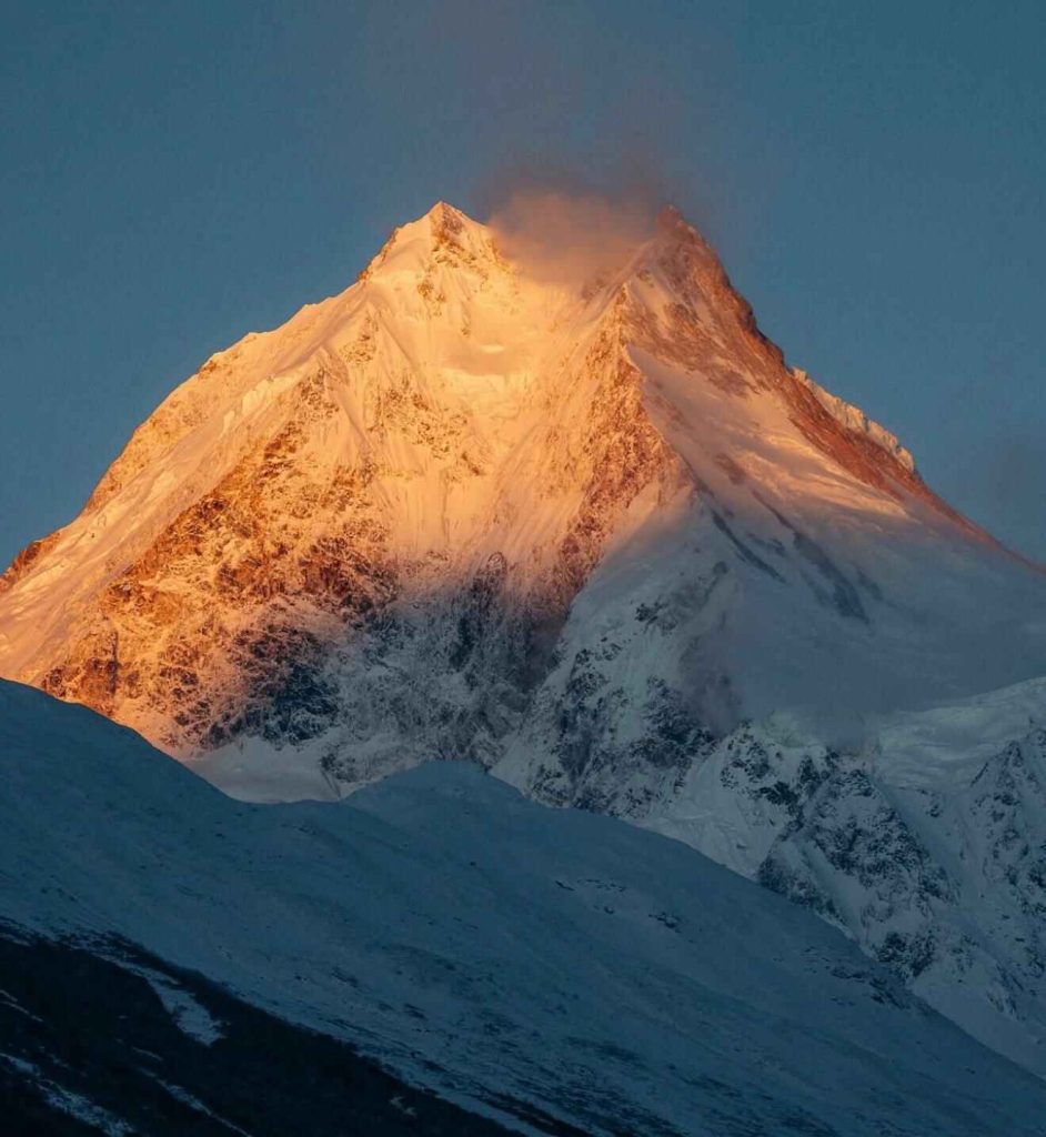 Golden sunrise on Mount Manaslu peak during the Manaslu Circuit Trek in Nepal.