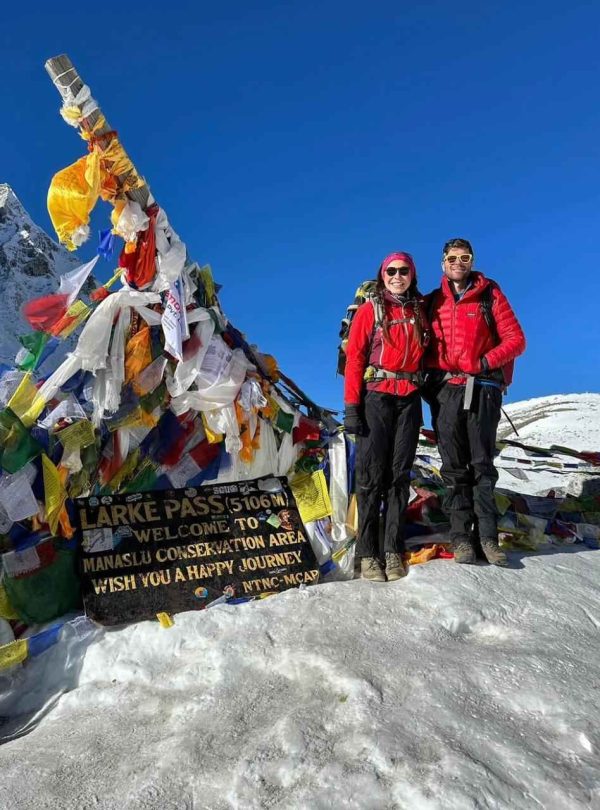Trekkers standing with Mount Manaslu in the background during the Manaslu Circuit and Tsum Valley Trek.