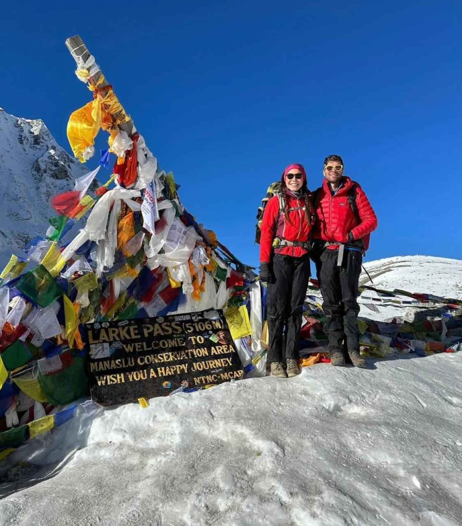 Trekkers standing with Mount Manaslu in the background during the Manaslu Circuit and Tsum Valley Trek.