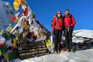 Trekkers standing at Larkya La Pass 5106m during the Manaslu Circuit Trek Difficulty journey