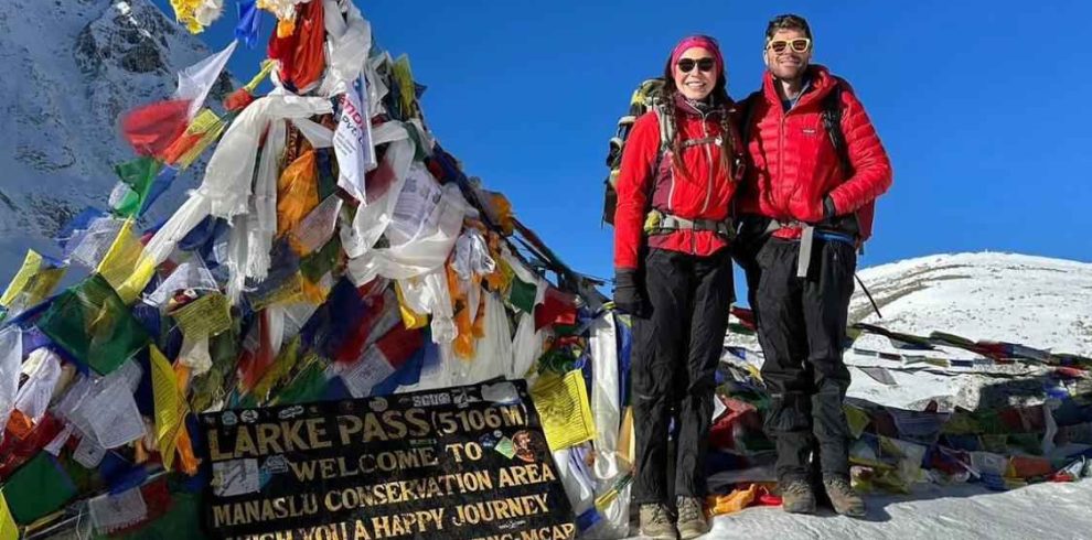 Trekkers standing at Larkya La Pass 5106m during the Manaslu Circuit Trek Difficulty journey
