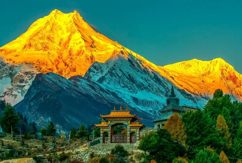 Sunrise view of Mount Manaslu with monastery and green hills on Manaslu Circuit trek Nepal